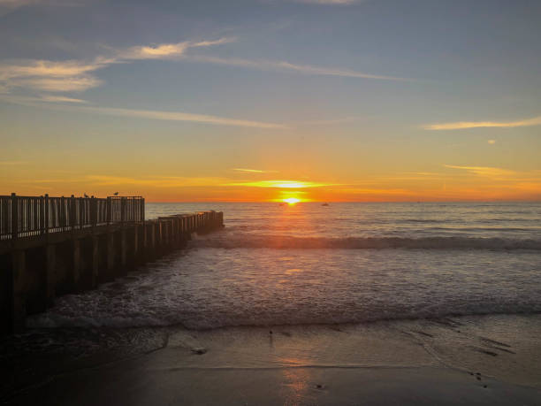 istock Sun sets over the pacific ocean in Playa del Rey as waves crash against rocks 1134336113