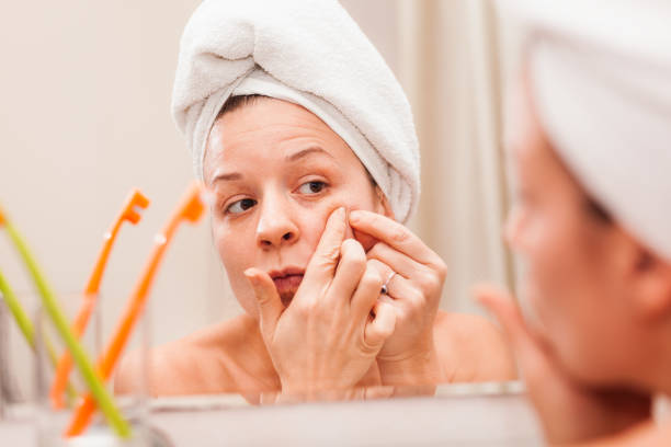 istock Young woman putting a cream on her face 1134340374