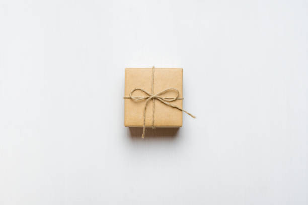 istock gift box tied with string on white wooden background 1134344592