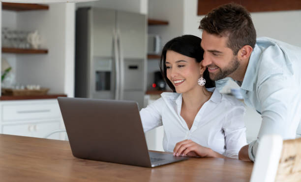 istock Couple at home looking at social media on a laptop computer 1134350085