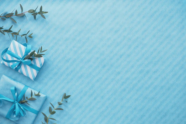 istock Flat lay in light blue with wrapped gift boxes decorated with eucalyptus twigs, copy-space 1134350118