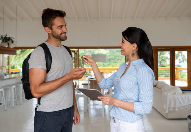 istock House sharing hostess handling the keys to a happy guest 1134350139