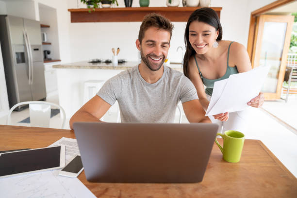 istock Loving couple paying bills online at home 1134350228
