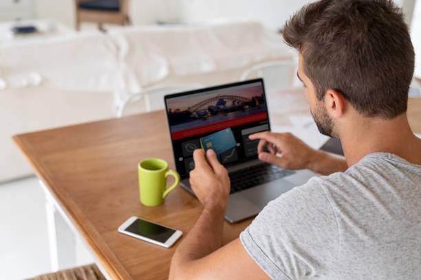 istock Man at home shopping online using a credit card 1134350235