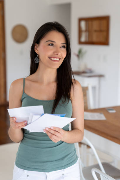 istock Happy woman at home checking the mail 1134350240