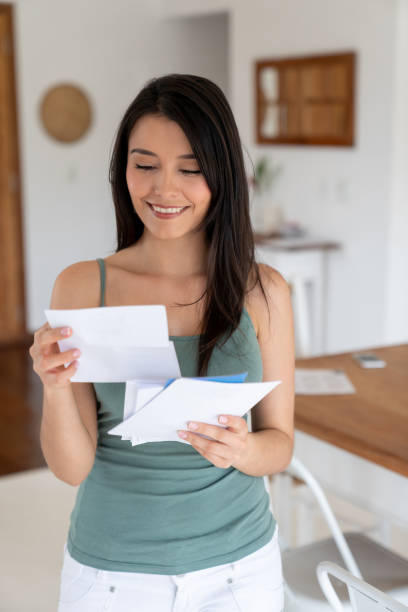 istock Beautiful woman at home checking the mail 1134350241