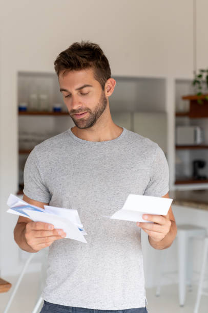 istock Brazilian man at home checking the mail 1134350248