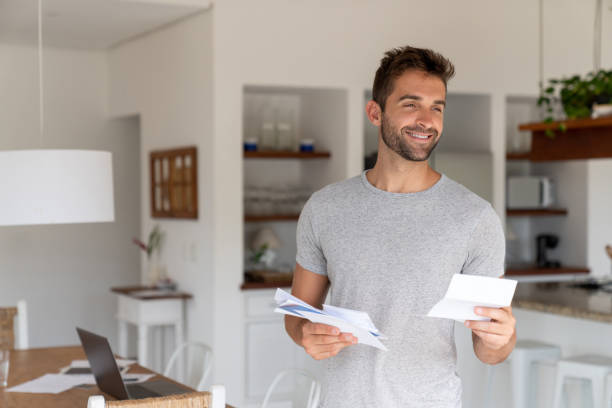 istock Happy man at home checking the mail 1134350250