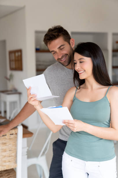 istock Happy couple at home checking the mail 1134350254