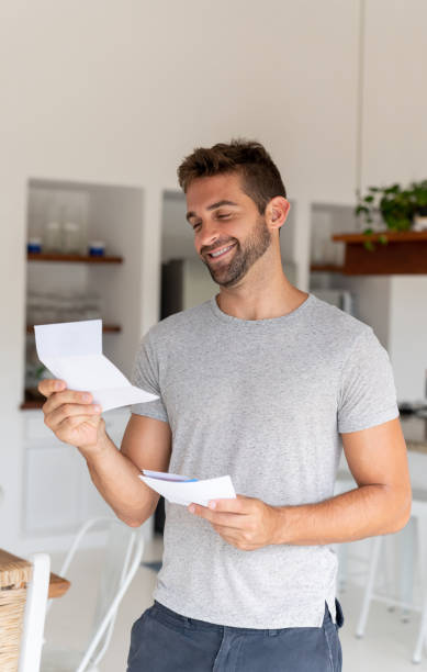 istock Man looking very happy at home getting a letter on the mail 1134350255