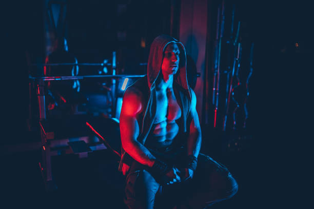 An African bodybuilder is intensely exercising in the gym, sweating profusely as they build strong muscles and strive for a healthy lifestyle.