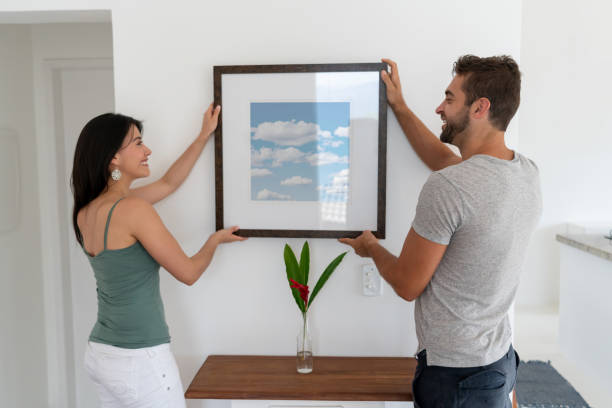 istock Couple hanging a picture at home 1134352235