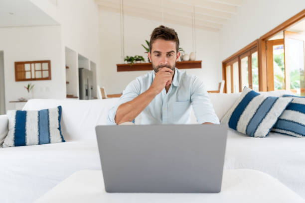 istock Thoughtful man working at home on his laptop computer 1134352240
