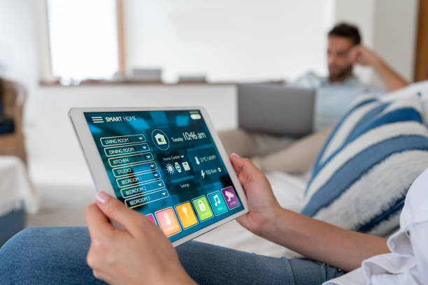 istock Close-up on a woman using a tablet computer to control her smart home 1134352252