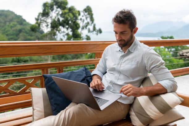 istock Man working online at home on the terrace working on a laptop computer 1134352263