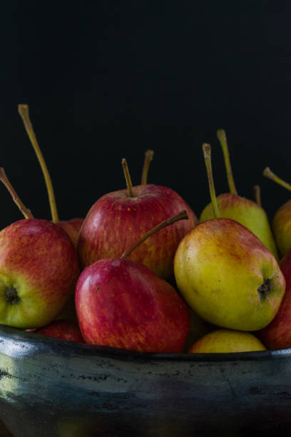 istock apples in black clay bowl on old wood 1134352472
