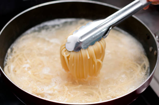 istock Pasta boiling in a pan with tongs 1134352483