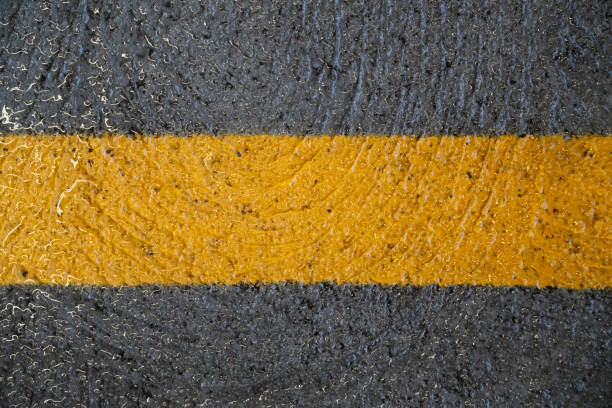 Detailed Close-up, Glossy, Textured Cement. Yellow Parking Line