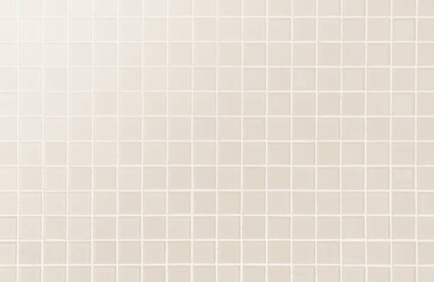 White or cream ceramic wall and floor tiles abstract background.