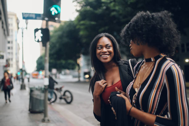 istock Two young female friends talking in downtown LA 1134360872