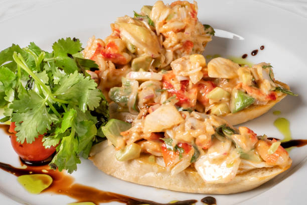 istock Bruschettas with vegetables, cheese and sauce on a white plate. 1134361355