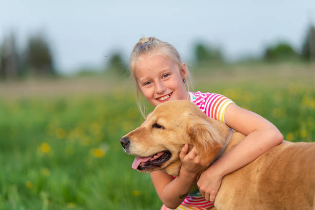 istock Little girl playing with her dog 1134361414