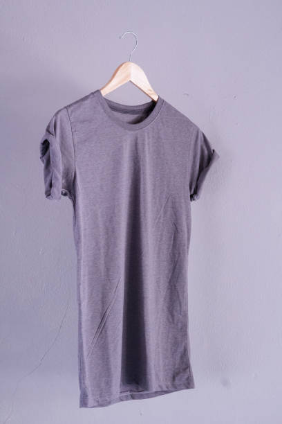 istock Retro fold grey cotton T-Shirt clothes mock up template on gray cement background concept for retail dress shop backdrop, Blank flat lay vintage grey wall plain laundry advertising 1134361433