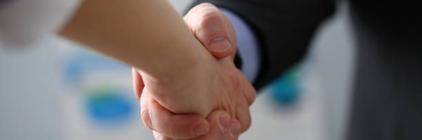 istock Man in suit and tie give hand as hello in office 1134361453