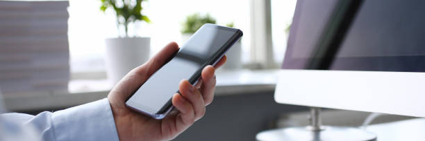 istock Businessman hipster holds telephone background of 1134361465