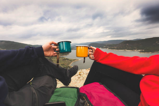 istock couple drinking coffee in enameled cup on mountain view 1134362431