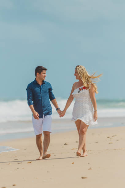 istock Passionate couple strolling on the beach 1134362518