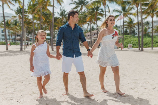 istock Family walking on the beach 1134362527