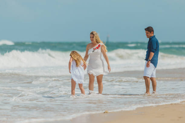 istock Family walking on the beach 1134362555