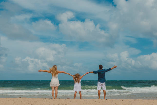 istock Family jumping on the beach 1134362570