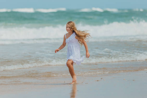 istock Blonde girl playing on the beach 1134362843