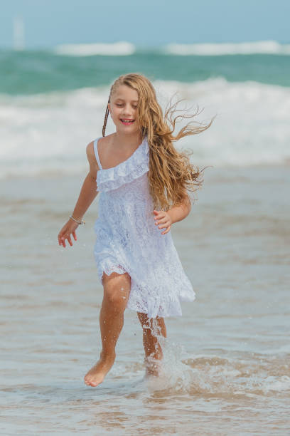 istock Blonde girl playing on the beach 1134362951