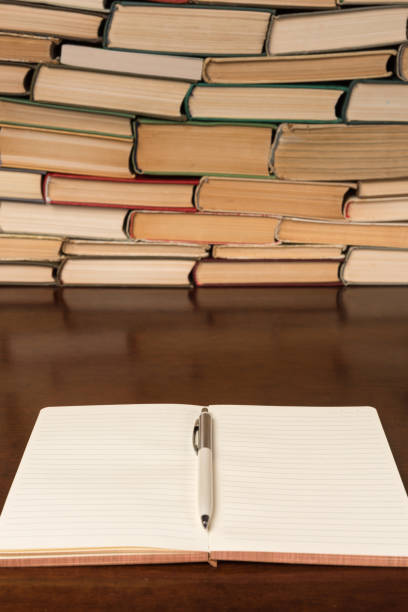 istock notebook and pen on the background of books 1134363012