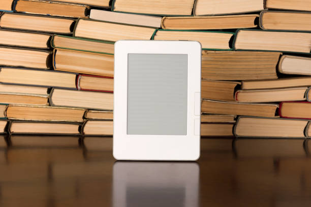 istock Electronic book on background of regular old books 1134363040