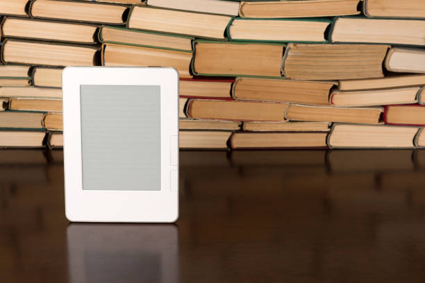 istock Electronic book on background of regular old books 1134363045