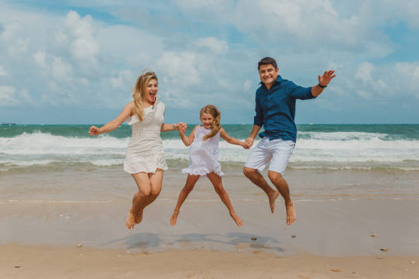 istock Family jumping on the beach 1134363055
