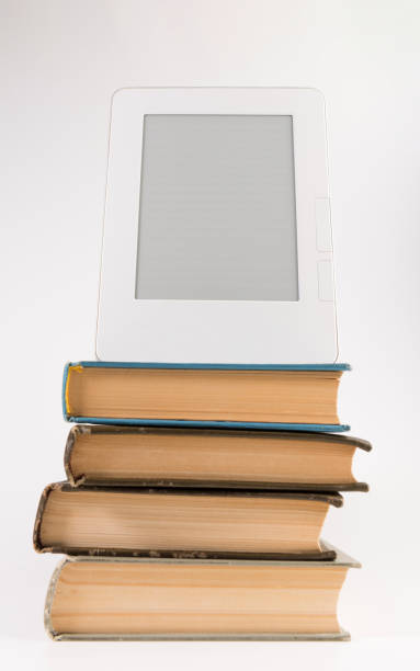 istock Electronic book on the top of the stack of regular old books isolated on white background 1134364094