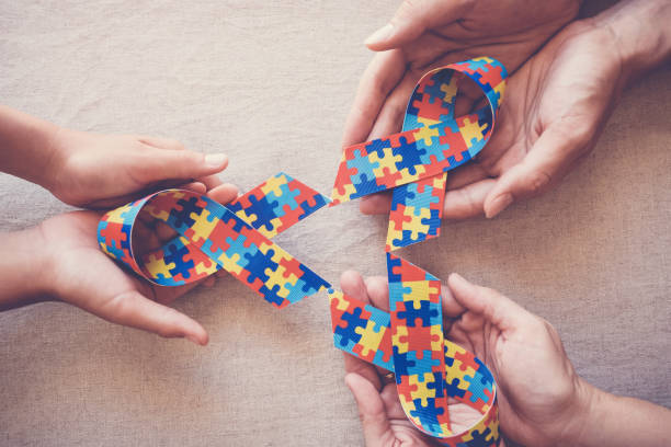 istock Hands holding puzzle ribbon for autism awareness 1134364123