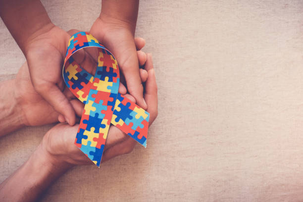 istock Hands holding puzzle ribbon for autism awareness 1134365962