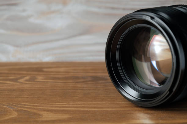 istock camera photo lens on old wooden table 1134366672