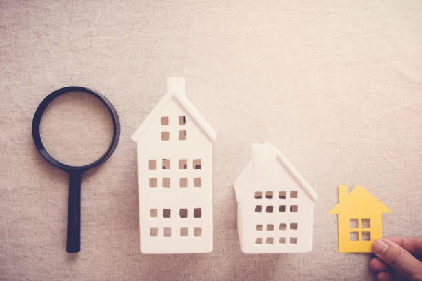 istock hand picking the right house property, house searching concept 1134367947