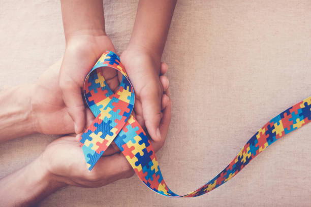 istock Hands holding puzzle ribbon for autism awareness 1134368508