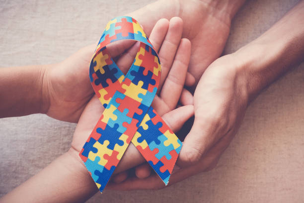 istock Hands holding puzzle ribbon for autism awareness 1134368628