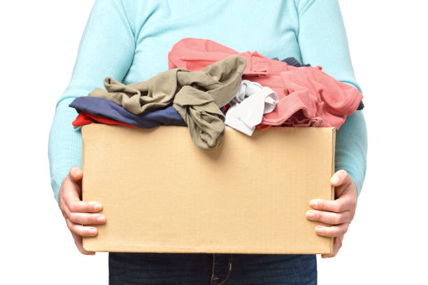 Volunteer with donation box with clothes used