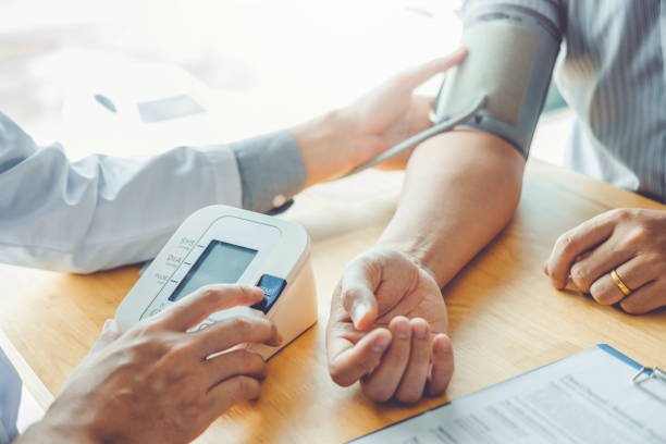 Doctor Measuring arterial blood pressure with man patient on arm Health care in hospital Doctor Measuring arterial blood pressure with man patient on arm Health care in hospital asian blood pressure stock pictures, royalty-free photos & images