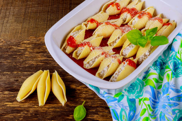 stuffed shells into baking dish ready to be cooked